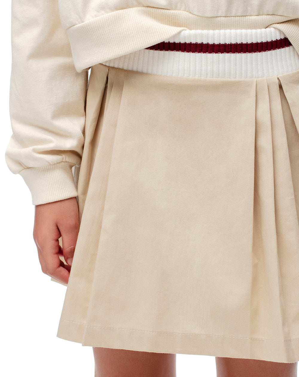 Falda corta con pliegues beige niña