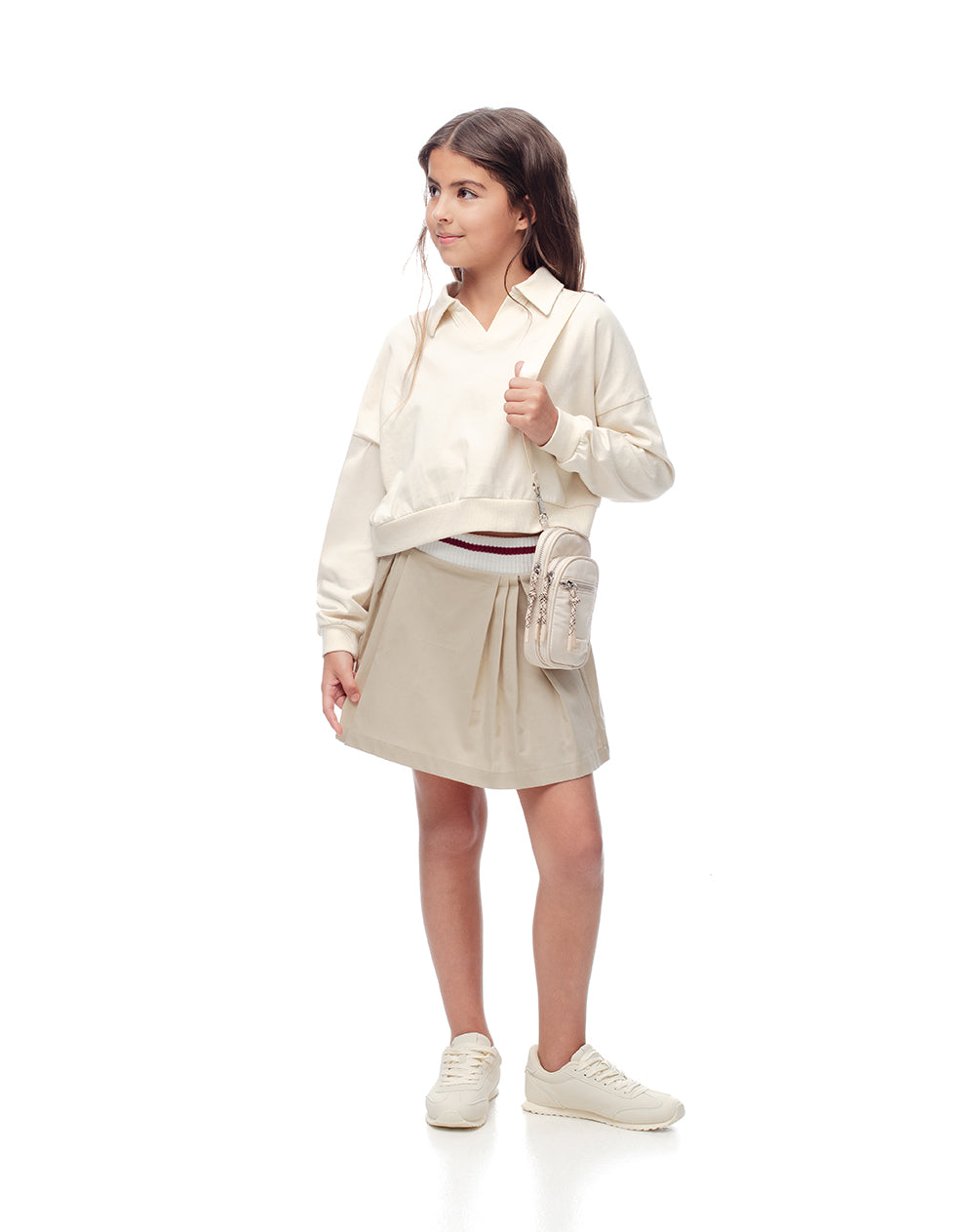 Falda corta con pliegues beige niña