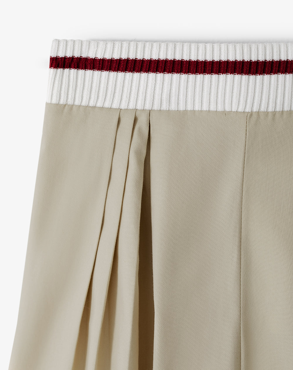 Falda corta con pliegues beige niña